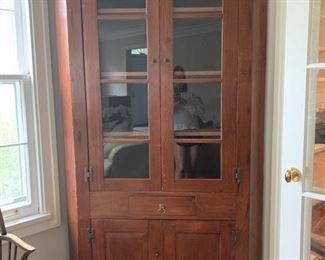 Antique Early American Corner Cabinet. Measures approximately 36" W x 82" H.