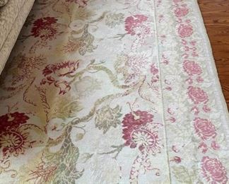 Floral wool area rug. Measures 6'3" x 8' 11.
