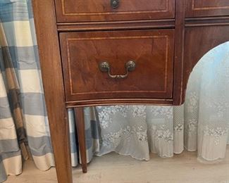 Serpentine front mahogany desk with glass top. Measures 44" W x 18.5" D. Photo 3 of 3.
