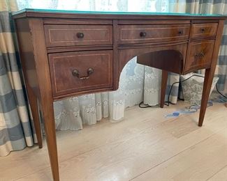 Serpentine front mahogany desk with glass top. Measures 44" W x 18.5" D. Photo 2 of 3.
