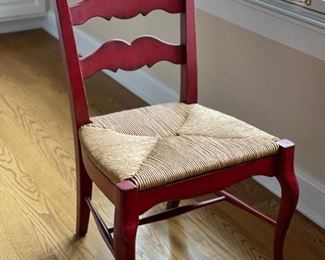 Pair of red ladder back chairs with rush seats. Photo 1 of 3.