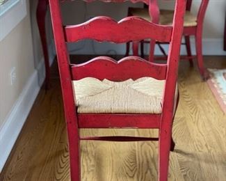 Pair of red ladder back chairs with rush seats. Photo 2 of 3.