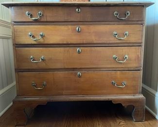 Four-drawer cherry chest of drawers. Measures 38.5" W x 19" D x 33.5."