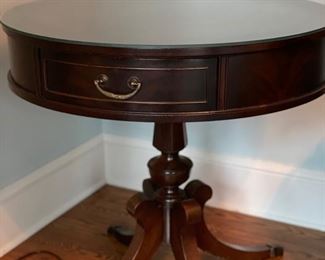 Leather top drum table with brass claw feet. Measures 28" D. Photo 1 of 3.