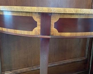 Pair of flame mahogany demi-lune tables with double satinwood banding. Each measures 35" W x 13.5" D x 29" H. Photo 3 of 3.