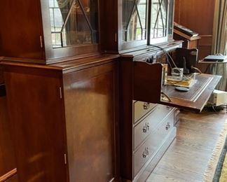 Trosby English traditional flame mahogany breakfront with leather-top drop-down desk / bar top and interior lighting. Measures 101" W x 88" W x 21" D. Photo 2 of 4.