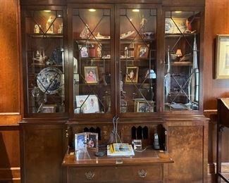 Trosby English traditional flame mahogany breakfront with leather-top drop-down desk / bar top and interior lighting. Measures 101" W x 88" W x 21" D. Photo 1 of 4.