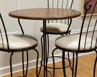 Old oak-top Bistro table with wrought iron base. Measures 30" D x 40" H.