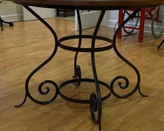 Old oak-top table with wrought iron pedestal base. Measures 48" D x 30" H. Photo 2 of 2.