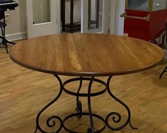 Old oak-top table with wrought iron pedestal base. Measures 48" D x 30" H. Photo 1 of 2.