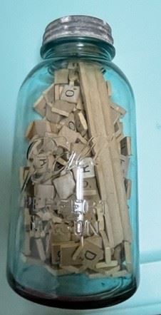 Mason jar with Scrabble letters.