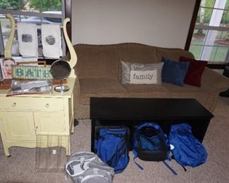wash stand, couch, coffee table, back packs