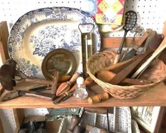 Lots of wooden and tin kitchenware and utensils.