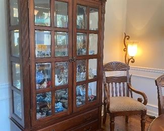Matching cherry China cabinet with glass shelving and dual lighting at top. Two drawers at bottom for extra storage. 