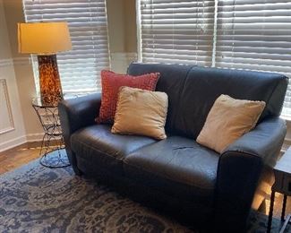 Ebony leather love seat with simplistic, clean  lines! 