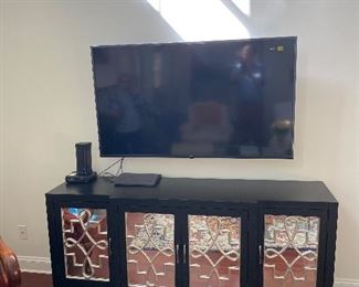 This TV stand is so awesome the TV just hovers above it. Maybe the ghosts in the reflection have something  to do with it.