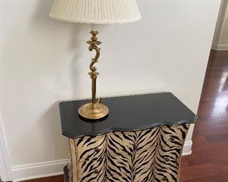 Animal print dresser with cool brass lamp.
