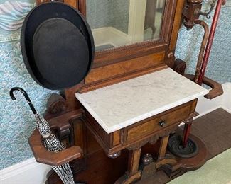 Cast iron umbrella drip catchers. Marble top. Hat hooks.