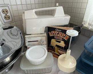 The Oster Kitchen Center complete with bowl, beaters, manual, and all attachments!