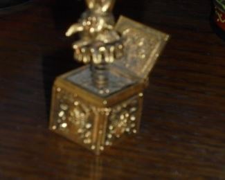 Mid century brass hypnotique 1oz Max Factor jack in the box