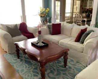 Rowe brand Living room ivory couch set with ottoman. Has slipcovers. 