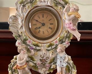 19th Century Dresden (No Mark) Porcelain Mantle Clock Garniture with Putti & Flowers. Set come with Matching Candleholders. One has been Fashioned Into A Lamp. Photo 1 of 2.