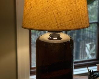 Pair of jug-style amber glass table lamps with natural fiber shades. Photo 2 of 2.