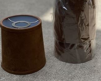 Brown suede chandelier shades.