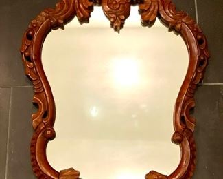 Small ornate cherry wood mirror. Would look great painted white for a coastal look and feel!