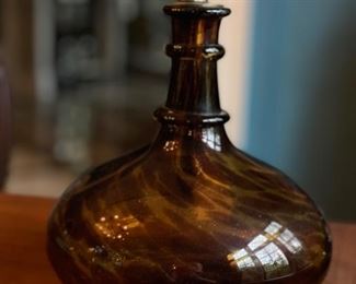 Tortoise shell blown glass decanter with brass stopper.