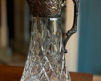 Cut crystal bar pitcher with silver plate lid and handle.