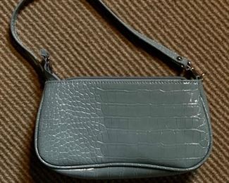 Light blue faux leather handbag.