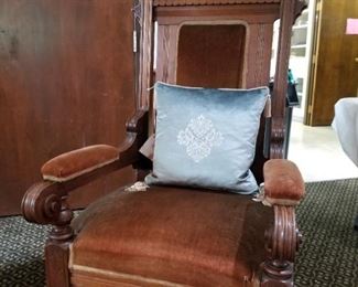A judges chair. Notice the crossed gavels in the crown of the chair. 