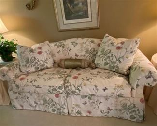 Custom floral upholstered skirted sofa