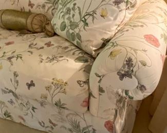 Custom floral upholstered skirted sofa