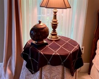 Pair of Round Bed Tables. The fabric matches the comforter set, and pair of brass table lamps