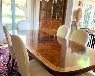Double pedestal dining table. Pictured with one leaf. Measures 8’3” x 4’. Additional leaf is 20” wide 