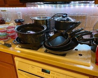 Pots and pans including a very large cast iron skillet 
