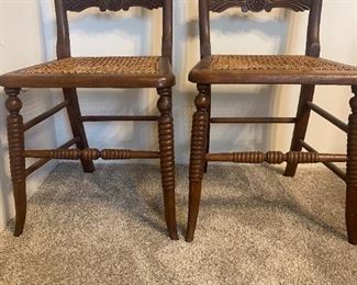 #28	(2) Antique Chairs w/cane Seating & Carved Wood Back - sold as a set	 $45.00 
