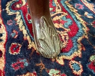 Foot of yellow upholstered batwing back chair