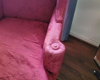 one of a pair of fuchsia wingback chairs 