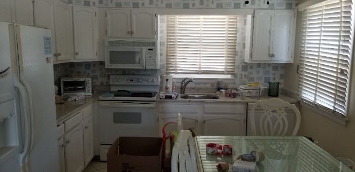Cute kitchen with clean white GE appliances