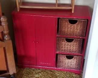 Cute red storage cupboard with baskets