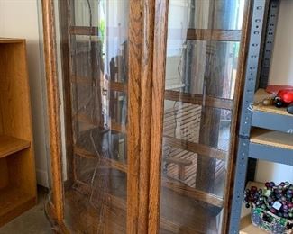 	#64	Lighted glass display cabinet with glass shelves and curved glass 42x13x63	 $125.00 	