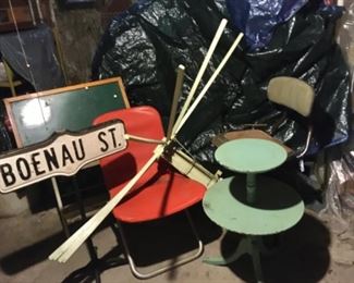 Metal Boenau St sign, orange fold up chair, wooden wall drying rack