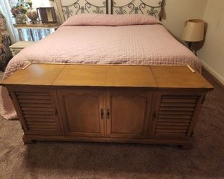 Bedroom with table at the end of the bed