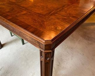 Burl wood extension table with fretwork trim. Measures 62" L  x 44" W x 30" H; extends to 104" W with two 21" Leaf.  26" clearance. Photo 2 of 5. 