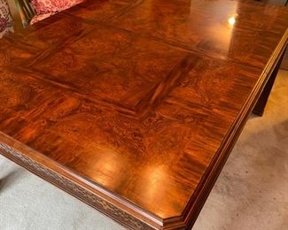 Burl wood extension table with fretwork trim. Measures 62" L  x 44" W x 30" H; extends to 104" W with two 21" Leaf.  26" clearance. Photo 3 of 5. 