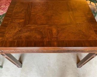 Burl wood extension table with fretwork trim. Measures 62" L  x 44" W x 30" H; extends to 104" W with two 21" Leaf.  26" clearance. Photo 4 of 5. 