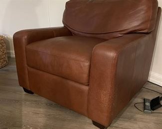 Leather upholstered club chair. There is some claw damage on the lower left side.  Photo 3 of 3. 